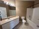 Bathroom featuring a vanity, toilet, bathtub, shower, and white tile flooring at 4305 Bayside Village Dr # 301, Tampa, FL 33615