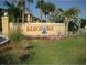Beachwalk community sign with palm trees and colorful flowers at 4305 Bayside Village Dr # 301, Tampa, FL 33615