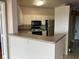 Kitchen with breakfast bar, white cabinetry and stainless steel appliances at 4305 Bayside Village Dr # 301, Tampa, FL 33615