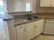 Kitchen sink with white cabinets, tile flooring, and modern faucet at 4305 Bayside Village Dr # 301, Tampa, FL 33615
