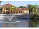 Scenic pond featuring a central fountain with community building in the background at 4305 Bayside Village Dr # 301, Tampa, FL 33615