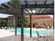 Community pool featuring a shaded seating area and easy access to nearby buildings at 4305 Bayside Village Dr # 301, Tampa, FL 33615