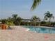 Relaxing community pool area with lounge chairs and a pergola for shade at 4305 Bayside Village Dr # 301, Tampa, FL 33615