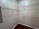 A walk-in closet featuring white walls, wire shelving, and hardwood floors at 4305 Bayside Village Dr # 301, Tampa, FL 33615