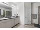 Elegant bathroom featuring dual sinks, granite countertops, and a separate shower area for added convenience at 5006 Jackel Chase Dr, Wimauma, FL 33598