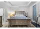 Comfortable bedroom showcasing a large bed, bedside table, and ample natural light from the window at 5006 Jackel Chase Dr, Wimauma, FL 33598