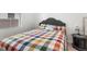 Cozy bedroom with a comfortable bed and colorful patchwork comforter, creating a welcoming atmosphere at 5006 Jackel Chase Dr, Wimauma, FL 33598