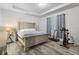 Spacious bedroom with modern flooring, tray ceiling, and exercise equipment for a healthy lifestyle at 5006 Jackel Chase Dr, Wimauma, FL 33598