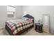 Comfortable bedroom with natural light, featuring a full size bed and simple décor at 5006 Jackel Chase Dr, Wimauma, FL 33598