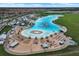 Aerial view of a community beach area with water park and lounging chairs for a resort-style experience at 5006 Jackel Chase Dr, Wimauma, FL 33598