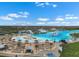 Aerial view of large community pool with beach entry and inflatable water park on a sunny day at 5006 Jackel Chase Dr, Wimauma, FL 33598