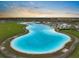 Aerial view of large community pool with beach entry and inflatable water park on a sunny day at 5006 Jackel Chase Dr, Wimauma, FL 33598