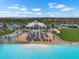 Community beach area with lounge chairs, umbrellas, and a covered gathering area for residents at 5006 Jackel Chase Dr, Wimauma, FL 33598