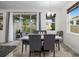 Dining room with elegant table set, bright windows, and patio access at 5006 Jackel Chase Dr, Wimauma, FL 33598