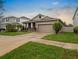 The home shows a well-maintained yard and driveway with a welcoming exterior at 5006 Jackel Chase Dr, Wimauma, FL 33598