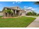 Charming single-Gathering home showcasing a well-manicured lawn and beautiful landscaping at 5006 Jackel Chase Dr, Wimauma, FL 33598