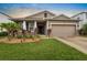 A beautiful single-Gathering home with a well-kept lawn and attached two-car garage at 5006 Jackel Chase Dr, Wimauma, FL 33598