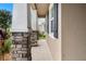 The home features a covered porch with stone-clad columns and professional landscaping at 5006 Jackel Chase Dr, Wimauma, FL 33598