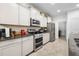 Modern kitchen boasting stainless steel appliances, granite countertops, and ample storage at 5006 Jackel Chase Dr, Wimauma, FL 33598