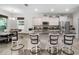 Well-lit kitchen with a breakfast bar featuring seating for four and stainless appliances at 5006 Jackel Chase Dr, Wimauma, FL 33598