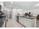 Well-lit kitchen features stainless steel appliances, a granite-topped island, and tile flooring at 5006 Jackel Chase Dr, Wimauma, FL 33598