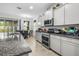 Spacious kitchen with granite countertops, modern appliances, and ample cabinet space at 5006 Jackel Chase Dr, Wimauma, FL 33598