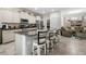 Bright, open kitchen featuring granite countertops, stainless steel appliances, and island seating at 5006 Jackel Chase Dr, Wimauma, FL 33598