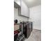 Well-organized laundry room featuring modern washer and dryer units and ample storage at 5006 Jackel Chase Dr, Wimauma, FL 33598