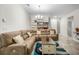 Inviting living room space with a large sectional sofa, neutral décor, and tile flooring at 5006 Jackel Chase Dr, Wimauma, FL 33598