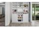 Open shelving for storage near sliding glass doors to backyard at 5006 Jackel Chase Dr, Wimauma, FL 33598