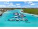 Aerial view of a large inflatable water park in the community lagoon, perfect for Gathering fun at 5006 Jackel Chase Dr, Wimauma, FL 33598