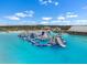 Community water park with unique inflatable slides and climbing features for recreational enjoyment at 5006 Jackel Chase Dr, Wimauma, FL 33598