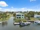 Aerial view of waterfront home with private dock, canal access and a screened-in porch for outdoor living at 5070 Cedarbrook Ln, Hernando Beach, FL 34607
