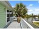 Balcony view of waterfront and the palm tree in the yard, a great place for relaxing or entertaining at 5070 Cedarbrook Ln, Hernando Beach, FL 34607