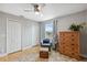 Bright bedroom featuring neutral walls, closet, ceiling fan, and an accent chair near window at 5070 Cedarbrook Ln, Hernando Beach, FL 34607