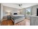 Serene bedroom featuring a queen-sized bed, wood floors, and soft natural lighting at 5070 Cedarbrook Ln, Hernando Beach, FL 34607