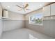 Bright bonus room with a ceiling fan and wainscotting panels at 5070 Cedarbrook Ln, Hernando Beach, FL 34607