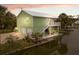 Waterfront home with a metal roof, two car garage, dock and an outdoor staircase to the living area and porch at 5070 Cedarbrook Ln, Hernando Beach, FL 34607