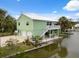 Two-story home with multiple garage doors, fenced yard and canal access at 5070 Cedarbrook Ln, Hernando Beach, FL 34607