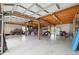 Large garage with exposed wooden beams and enough space for lots of storage at 5070 Cedarbrook Ln, Hernando Beach, FL 34607