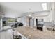Spacious kitchen with stainless steel appliances and a breakfast bar overlooking the living room at 5070 Cedarbrook Ln, Hernando Beach, FL 34607