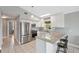 Bright kitchen featuring stainless steel appliances, granite countertops, and tile flooring at 5070 Cedarbrook Ln, Hernando Beach, FL 34607