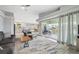 Bright living room featuring an area rug and access to an outdoor deck for seamless indoor-outdoor living at 5070 Cedarbrook Ln, Hernando Beach, FL 34607
