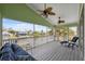 Relax and enjoy the scenic waterfront view from this spacious screened-in porch with ceiling fans and comfortable seating at 5070 Cedarbrook Ln, Hernando Beach, FL 34607