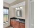 Bright bathroom with updated lighting and granite counters at 5078 Florentine Ct, Spring Hill, FL 34608