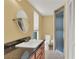 Bathroom with granite counters, large mirror, window and updated shower at 5078 Florentine Ct, Spring Hill, FL 34608