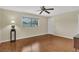 A cozy bedroom with ceiling fan, wood flooring, and a bright window at 5078 Florentine Ct, Spring Hill, FL 34608