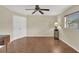 Bedroom with wood flooring, ceiling fan, and bright window light at 5078 Florentine Ct, Spring Hill, FL 34608