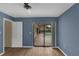 Bedroom with hardwood floors, door and sliding glass doors overlooking pool at 5078 Florentine Ct, Spring Hill, FL 34608