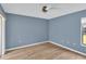 Bedroom with hardwood floors and a sliding glass door to the back yard at 5078 Florentine Ct, Spring Hill, FL 34608